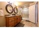 Main bathroom with double sinks, wooden vanity, granite counter, and glass shower at 3597 Cochise Ln, Las Vegas, NV 89169