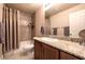 Bathroom has a shower/tub combo, vanity with granite countertop and large mirror at 3597 Cochise Ln, Las Vegas, NV 89169