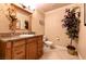 Bathroom with tile flooring, wooden vanity, granite counter, and decorative plants at 3597 Cochise Ln, Las Vegas, NV 89169