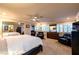Spacious main bedroom suite with wall mirror, and an adjacent sitting area with comfortable chairs at 3597 Cochise Ln, Las Vegas, NV 89169