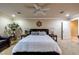 Comfortable bedroom features a ceiling fan, neutral walls, and a nautical themed decor at 3597 Cochise Ln, Las Vegas, NV 89169
