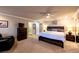 Carpeted main bedroom with furniture, fan, and doors leading to the bathroom at 3597 Cochise Ln, Las Vegas, NV 89169