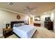 Bedroom with a ceiling fan, neutral walls, and matching end tables with lamps at 3597 Cochise Ln, Las Vegas, NV 89169