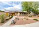Charming single-story home with desert landscaping and a walkway leading to a bright yellow front door at 3597 Cochise Ln, Las Vegas, NV 89169