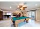 A view of the game room with a pool table, seating and adjacent living spaces at 3597 Cochise Ln, Las Vegas, NV 89169