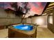 A luxurious hot tub with a lighted interior provides the perfect place to relax and unwind in a backyard setting at 3597 Cochise Ln, Las Vegas, NV 89169