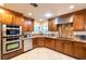 Well-lit kitchen with custom wood cabinets, stainless steel appliances, and granite countertops at 3597 Cochise Ln, Las Vegas, NV 89169