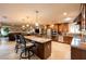 Open concept kitchen featuring bar seating, granite countertops, stainless appliances and views of the living room at 3597 Cochise Ln, Las Vegas, NV 89169