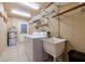 Laundry room includes a washer, dryer, utility sink, and wire shelving at 3597 Cochise Ln, Las Vegas, NV 89169