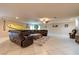 Expansive living room with a large sectional sofa, tile flooring, and a ceiling fan at 3597 Cochise Ln, Las Vegas, NV 89169