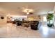 Expansive living room flowing into the kitchen, featuring a large sectional sofa and tile flooring at 3597 Cochise Ln, Las Vegas, NV 89169