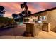 Outdoor kitchen with a stainless steel grill, tile countertop, and shaded dining area perfect for entertaining at 3597 Cochise Ln, Las Vegas, NV 89169