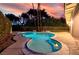 Sparkling kidney-shaped pool with a built-in spa, surrounded by lush landscaping and a private patio area at 3597 Cochise Ln, Las Vegas, NV 89169