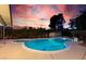 Inviting in-ground pool surrounded by a concrete deck and privacy landscaping providing a serene backyard escape at 3597 Cochise Ln, Las Vegas, NV 89169