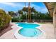Inviting pool with clear blue water, surrounded by lush landscaping and patio area at 3597 Cochise Ln, Las Vegas, NV 89169