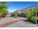 Well-maintained backyard featuring concrete and brick patio areas, lush greenery, and a private setting for relaxation at 3744 Alpine Bypass Ave, North Las Vegas, NV 89081