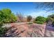 Inviting backyard with mature landscaping, brick patio, and string lights, perfect for outdoor entertaining and relaxation at 3744 Alpine Bypass Ave, North Las Vegas, NV 89081
