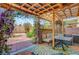 Relaxing covered backyard patio with ample seating and lighting at 3744 Alpine Bypass Ave, North Las Vegas, NV 89081