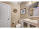 Updated half bathroom featuring a modern vanity, toilet, and decorative artwork at 3744 Alpine Bypass Ave, North Las Vegas, NV 89081