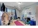 Bedroom with workspace, decorated blue floral wallpaper, and bright natural light at 3744 Alpine Bypass Ave, North Las Vegas, NV 89081