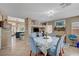 Bright dining area featuring tile flooring, a decorative chandelier, and an open floor plan at 3744 Alpine Bypass Ave, North Las Vegas, NV 89081