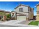 Well-maintained two-story home with attached two-car garage, green grass, and desert landscaping at 3744 Alpine Bypass Ave, North Las Vegas, NV 89081
