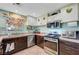 Modern kitchen featuring stainless appliances, white and brown cabinetry, and an eat-in sink at 3744 Alpine Bypass Ave, North Las Vegas, NV 89081