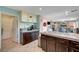 Open kitchen featuring stone countertops, stainless appliances, and view into adjoining dining area at 3744 Alpine Bypass Ave, North Las Vegas, NV 89081