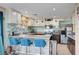Kitchen featuring stone countertops, stainless appliances, bar seating, and updated cabinetry at 3744 Alpine Bypass Ave, North Las Vegas, NV 89081