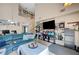 Bright living room with a soaring ceiling, comfortable blue sofa, a bookshelf, and neutral decor at 3744 Alpine Bypass Ave, North Las Vegas, NV 89081