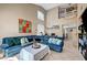 Inviting living room featuring a vaulted ceiling, tiled floor, and comfortable seating on a blue sectional sofa at 3744 Alpine Bypass Ave, North Las Vegas, NV 89081