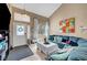 Cozy living room with a large sectional sofa, bright natural light, and tiled flooring throughout at 3744 Alpine Bypass Ave, North Las Vegas, NV 89081