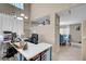 Functional home office area with a large desk setup, overhead shelving, and natural light at 3744 Alpine Bypass Ave, North Las Vegas, NV 89081