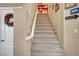 Carpeted staircase leading to the upper level, complemented by fresh paint and a charming decorative wreath at 3744 Alpine Bypass Ave, North Las Vegas, NV 89081