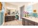 Spacious bathroom with double vanity sinks, ample lighting, a makeup area with a vanity chair, and a walk-in shower at 408 Middlestone Ave, Henderson, NV 89011