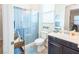 Well-lit bathroom with a glass-enclosed shower and vanity with dark wood cabinets at 408 Middlestone Ave, Henderson, NV 89011