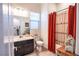 Bathroom featuring a vanity with mirror, toilet, and a shower with a decorative red curtain at 408 Middlestone Ave, Henderson, NV 89011