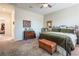 Bedroom featuring a metal bed frame, decorative area rug, ceiling fan, and a classic wooden dresser at 408 Middlestone Ave, Henderson, NV 89011