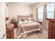 Cozy bedroom with neutral decor, carpet flooring, and a large window with blinds at 408 Middlestone Ave, Henderson, NV 89011