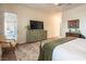 Relaxing bedroom with a patio door and a flat-screen TV above a wooden dresser and a chair at 408 Middlestone Ave, Henderson, NV 89011