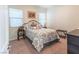 Cozy bedroom with a decorative iron bed frame, two windows and neutral decor at 408 Middlestone Ave, Henderson, NV 89011