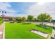 Community green space featuring horseshoe pits, mature trees, landscaping, benches, and walking paths at 408 Middlestone Ave, Henderson, NV 89011