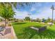 Beautifully landscaped common area with benches, green spaces, and horseshoe pits for outdoor enjoyment at 408 Middlestone Ave, Henderson, NV 89011