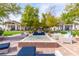Charming outdoor lounge area with comfortable seating, a fire pit, and lush landscaping at 408 Middlestone Ave, Henderson, NV 89011