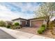 Contemporary home exterior features a two-bay garage, a one-bay garage, and a well-maintained front yard at 408 Middlestone Ave, Henderson, NV 89011