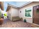 Charming front entrance with a decorative door, brick pavers, and a cozy bench at 408 Middlestone Ave, Henderson, NV 89011