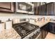 A kitchen gas range and stainless steel appliances with granite countertops and cabinetry at 408 Middlestone Ave, Henderson, NV 89011