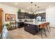 A modern kitchen with stainless steel appliances, granite countertops, seating at the island and dark brown cabinetry at 408 Middlestone Ave, Henderson, NV 89011