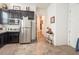 Modern kitchen featuring black cabinetry, stainless steel appliances, tile floors and an open layout at 408 Middlestone Ave, Henderson, NV 89011