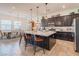 A spacious kitchen featuring a large island with seating and pendant lighting, as well as stainless steel appliances at 408 Middlestone Ave, Henderson, NV 89011